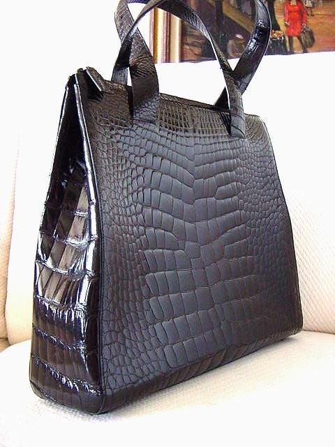 Sublime jet black $28,000.00 CROCODILE PRADA tote style bag that is a true collectors item! <br />
Gorgeous clean lines with a top zipper closure.  Zipper toggle is crocodile. <br />
The handles are double sided crocodile. <br />
The base has 4