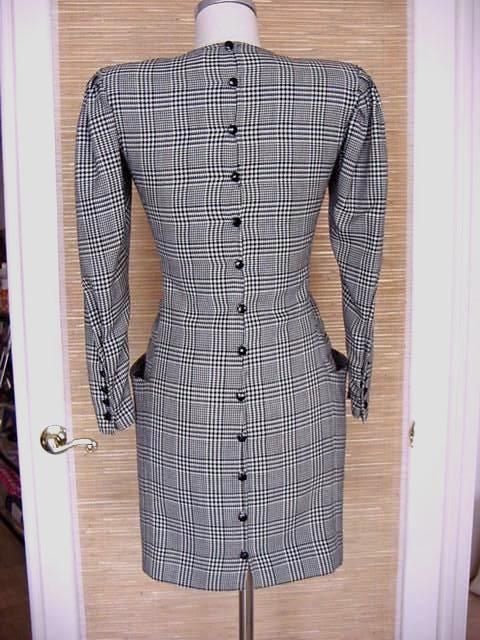 Guaranteed authentic Emanuel Ungaro  superbly fitted vintage dress in black and white houndstooth. 
The rouching at the waist and the pockets accentuate your curves.  
The sleeve is full, beautifully pleated at the shoulder - and narrows to a tight