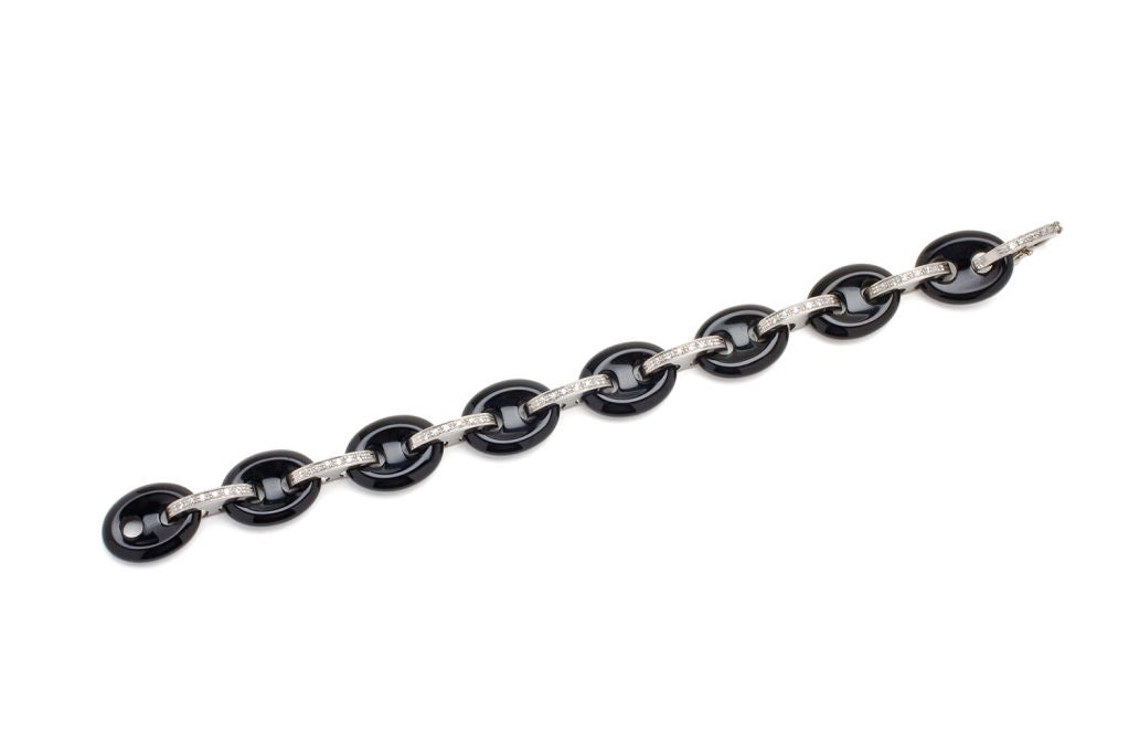 An Art Deco onyx  and diamond  link bracelet set in platinum.
Made and signed by Mappin & Webb. Interspersed with diamonds.
A most elegant look.