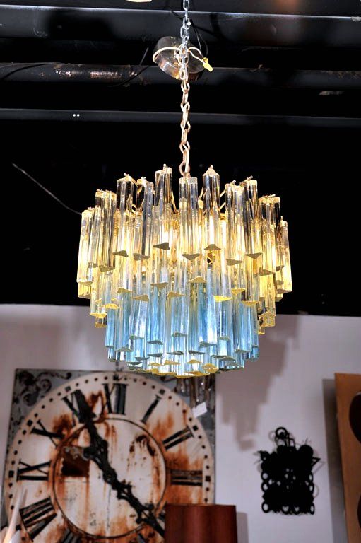 A Murano glass chandelier by Camer, NYC (signed) with sculptural, three-sided clear crystals and a center circle of baby blue crystals. Its neat, modest proportions allow for placement in various settings.