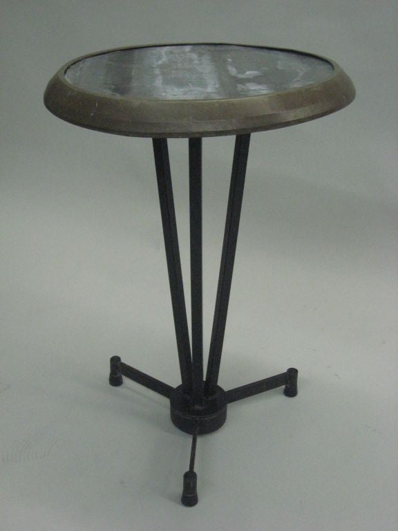  2 Elegant French Mid-Century Modern side tables / cafe tables composed of a steel tripod base and frame, zinc tabletop surrounded by a bronzed border. 
These authentic French pieces have a unique design drawing from early modernism and industrial