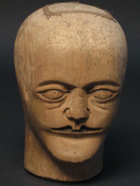 Hand carved mannequin head, with detailed face, used for display or wig forms.<br />
3-Available, priced individually.