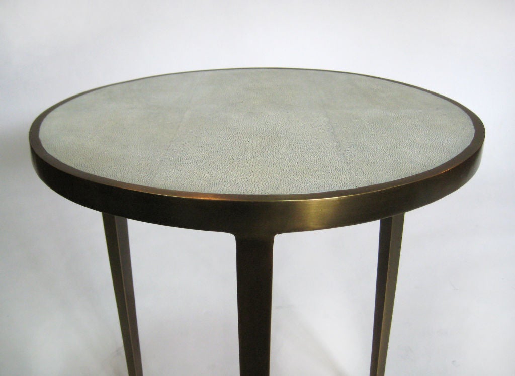 CHECK AVAILABILITY / AVAILABLE BY SPECIAL ORDER<br />
<br />
+ Handmade Table in Shagreen & Bronze<br />
+ Three bronze legs support the cast circular top<br />
+ Thin exterior bronze border on top surrounds a circular top of bone colored