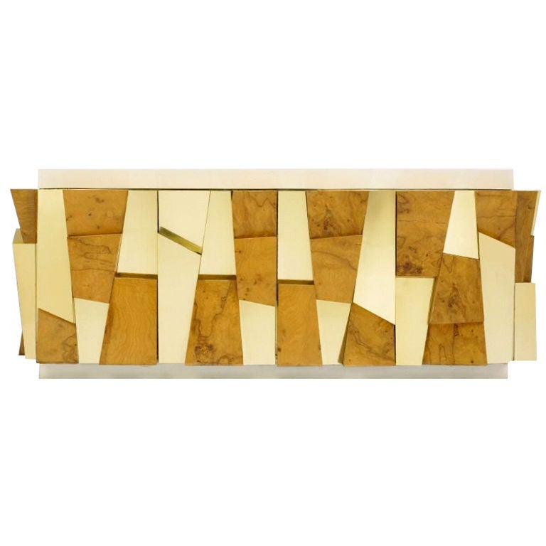 Paul Evans Studio for Directional faceted cabinet, USA, c. 1970.
Maple burl, brass, enameled fiberglass.
Cabinet features two bi-fold doors concealing two storage compartments and a single adjustable shelf.