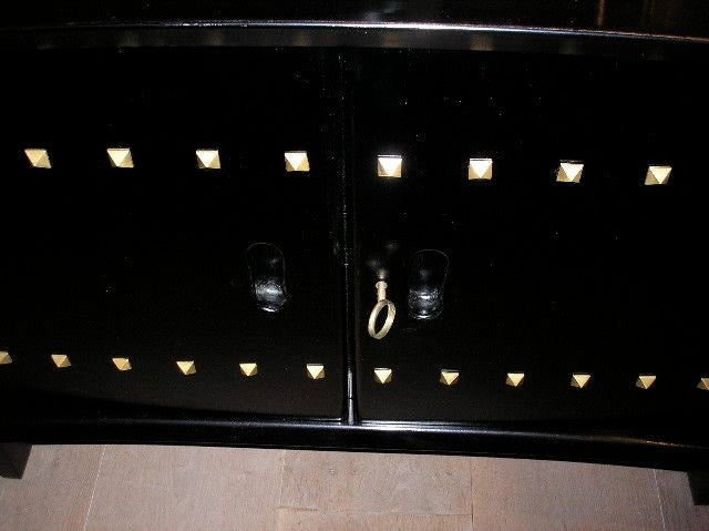 A  bronze studded ebonised wood sideboard