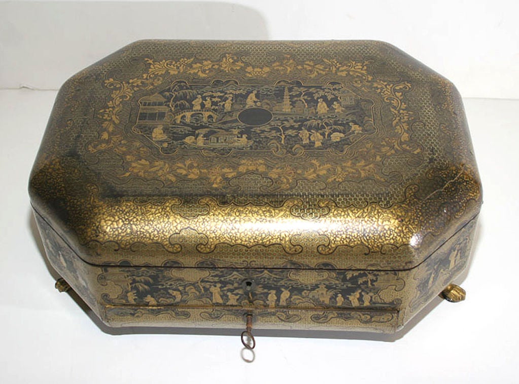OF OCTOGONAL FORM, DECORATED OVERALL WITH FIGURES IN GARDEN SCENES, THE INSIDE WITH A TRAY DIVIDED INTO COMPARTMENTS AND CONTAINING SEWING IMPLEMENTS, FITTED WITH A DRAWER COVERED BY A HINGED PANEL THAT OPENS TO REVEAL THE DRAWER WELL, RAISED ON