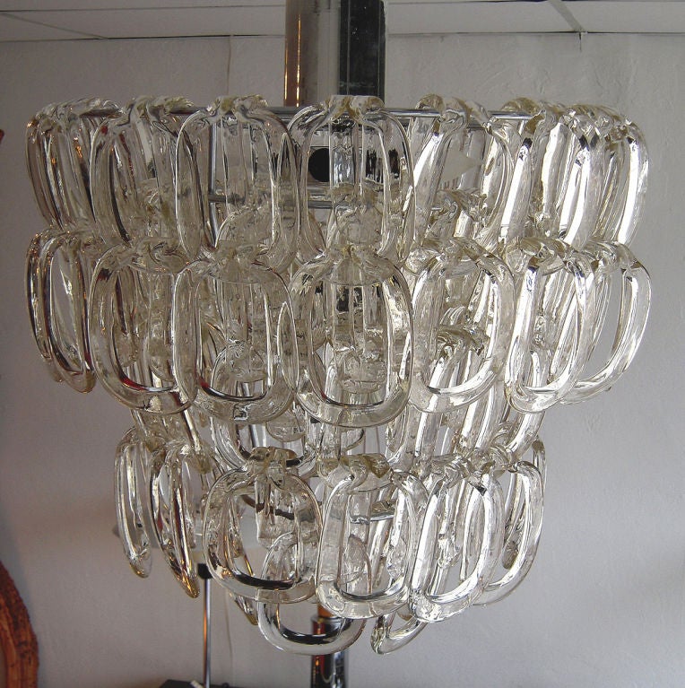 Elegant yet modern chandelier designed with individual italian glass links that connect or clip onto each other to form the tiers.  Each link is 5.5