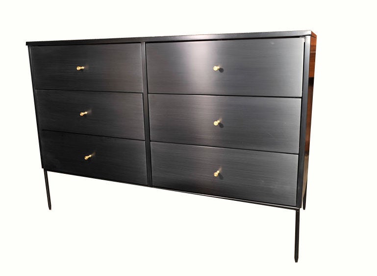 Paul McCobb six-drawer planner group dresser on iron base with original solid brass conical pulls. Solid birch construction throughout with a hand rubbed black lacquer finish, fully restored inside and out.