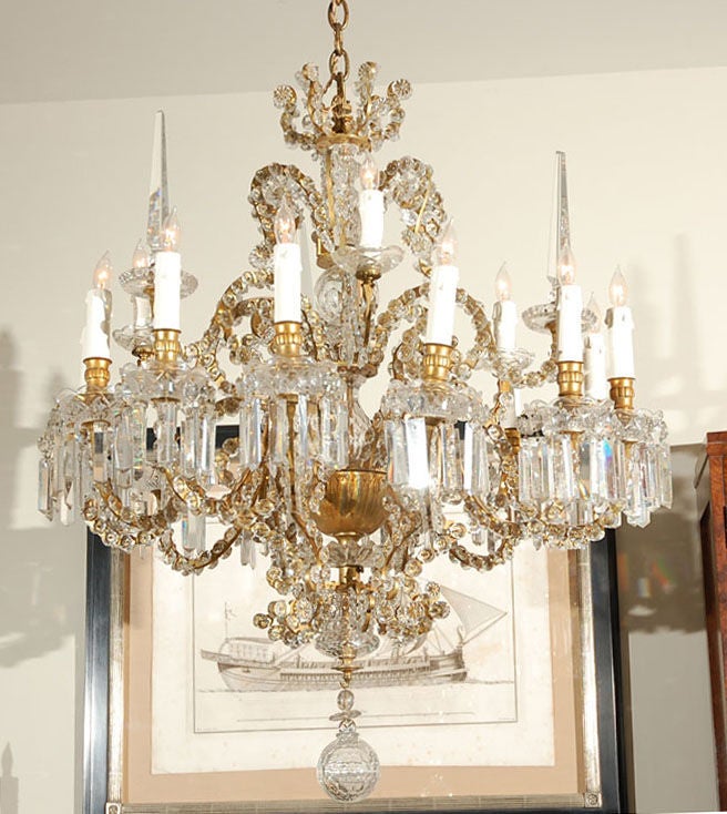 Opulent Bagues - Cut Glass Fleurette-Encrusted Gilded Brass Fifteen Light Chandelier in the Louis XV Taste. Elaborately Modeled with Tiered Candle Arms, Cut Glass Bobeches of Bowl Form, cut Prisms and Cut Glass Spikes