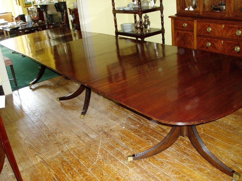 This large and beautiful 3-pedestal dining table seats 16 comfortably for a dinner party and could accommodate even more for a family holiday dinner. The table is made of richly grained mahogany, with the tops and leaves each of single-board