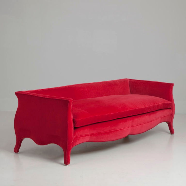 A Standard Low Back French Style Ruby Velvet Upholstered Sofa by Talisman Bespoke. This streamlined adaptation of the signature Talisman Bespoke French style sofa is designed with a low back more suited to specific interiors.  This sofa is available