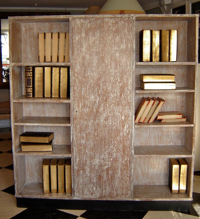Cerused oak bookshelves with a dry bar in the closed section.