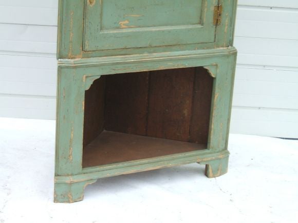 antique top with new base painted corner cabinet with opening at the bottom