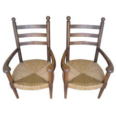 Pair of French Oak and Rush arm chairs,   Charlotte Perriand