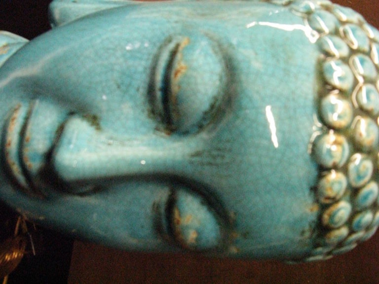 Pair  of glazed ceramic  buddha heads . 1