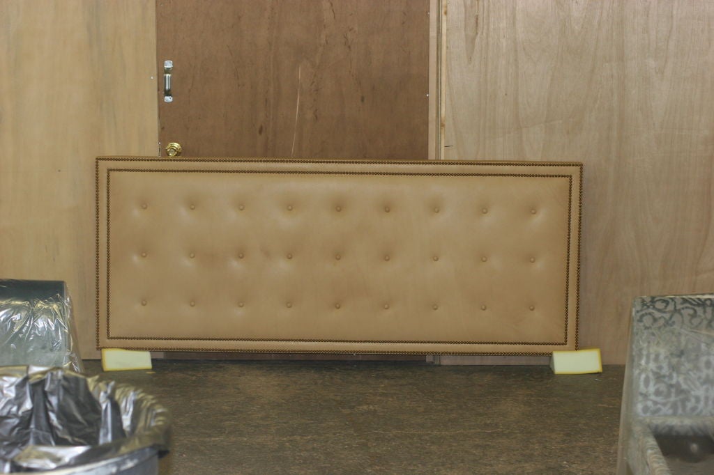 supple camel leather Headboard with matching buttons and brass Nail-heads.