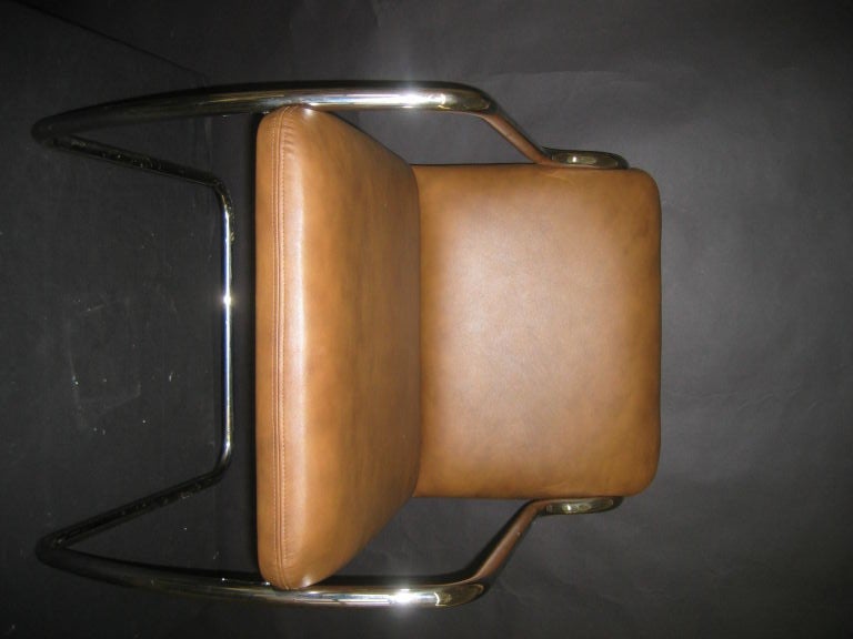 sleek polished stainless steel dining, desk or occasional chairs just reupholstered in a rich saddle colored leather