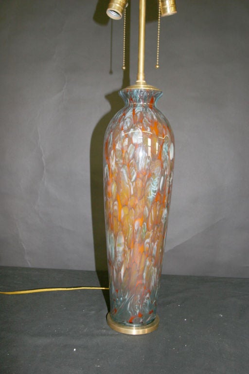 Hand blown colorful vases with brushed brass base and lamp application.