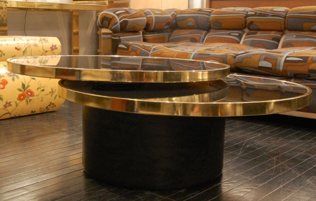 Coffee table with 360 degree swiveling black glass top and brass banding with base covered in black leather, Italy 1970's