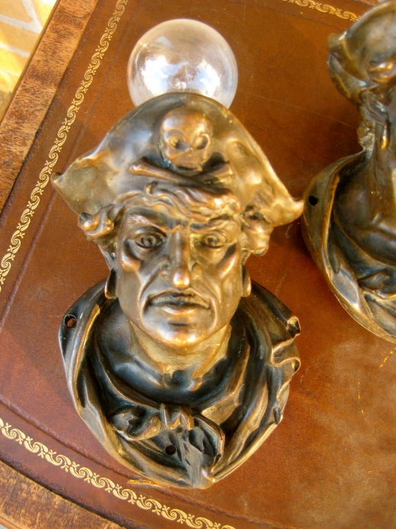 Exceptional pair of Caldwell bronze pirate sconces. Stamped Caldwell.