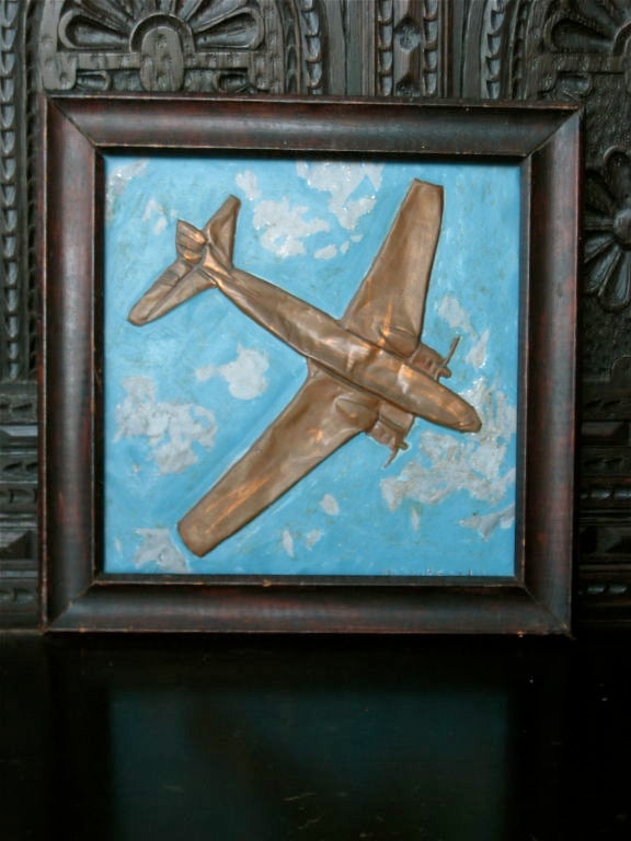 Delightful folk art copper plane framed against clouds.