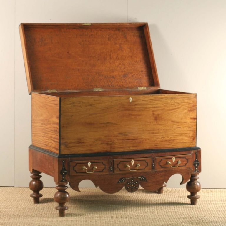 Indo-Dutch colonial storage trunk made of solid satinwood with ebony details. The trunk is made of solid single planks of beautifully figured satinwood. Base has ebony and ivory inlay details and ebony trim. Three drawers in bottom frieze with ebony