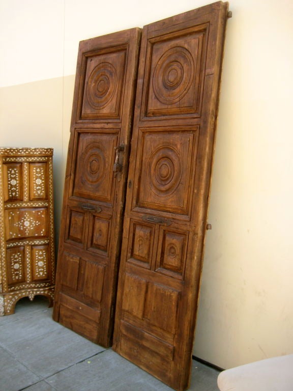 Beautifully carved Spanish doors with iron hardware.
