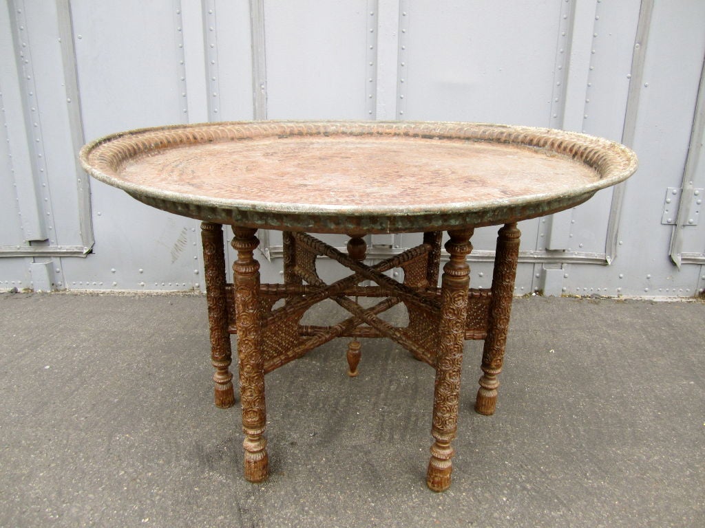 Extra large hammered copper tray table on carved and ebonized wood base. Tables of this size are extremely difficult to find.
