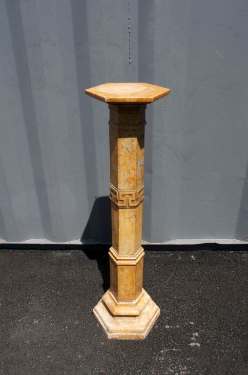 Beautifully carved onyx pedestal with Greek key design.