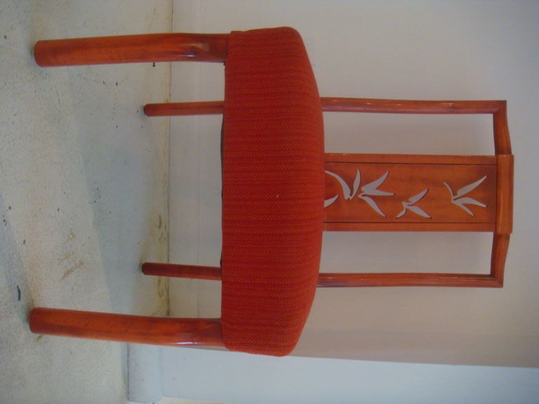 A set of 8 James Mont Dining Chairs from the estate of a personal friend of James Mont. They are in there original orange red stainwhich works so well with the asian inspired leaf design of the chair.The chairs have a most unusual shape to the front