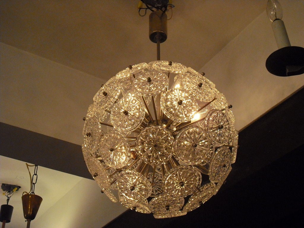A chrome fixture with 40 cut crystal glass disks. 10 light sources.Sale price noted