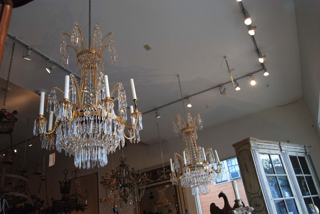 Fabulous pair of bronze and crystal chandeliers.