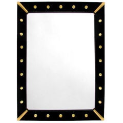 AMERICAN  BLACK REVERSE-PAINTED GLASS MIRROR WITH BRASS CORNERS
