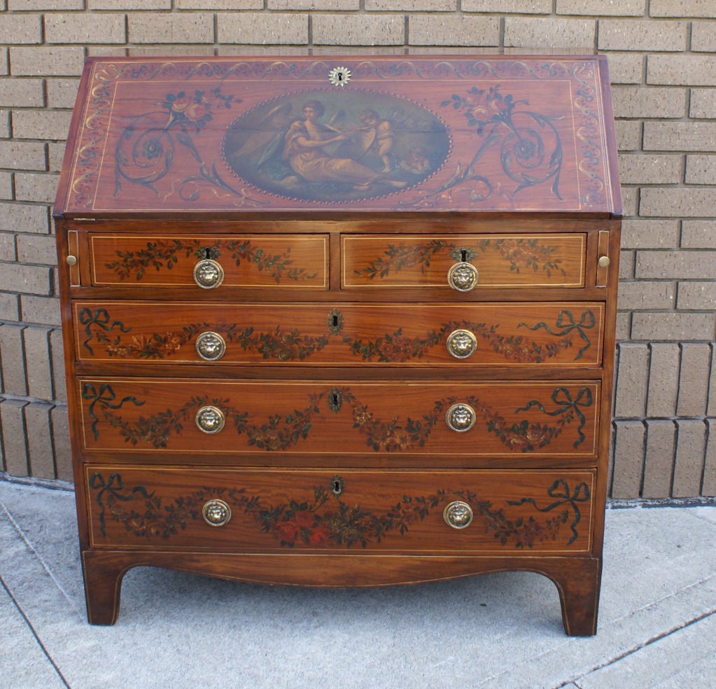A fancy painted satinwood slant front desk made in England during the first part of the 19th century.