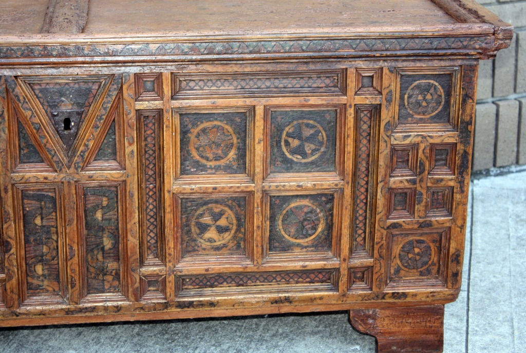 The rectangular hinged top with compound moulded edge, over conforming case enclosing a small side box for valuables, raised on bracket feet, the whole enriched with geometric patterns.