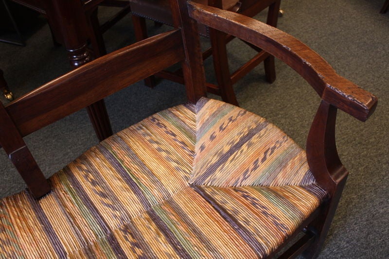 An antique three seat bench from France. Back and arms have a lovely shape. The original decorative rush is most unique. Made of walnut with a warm glow and patina. Sturdy and comfortable.<br />
<br />
See similar examples of antique benches on