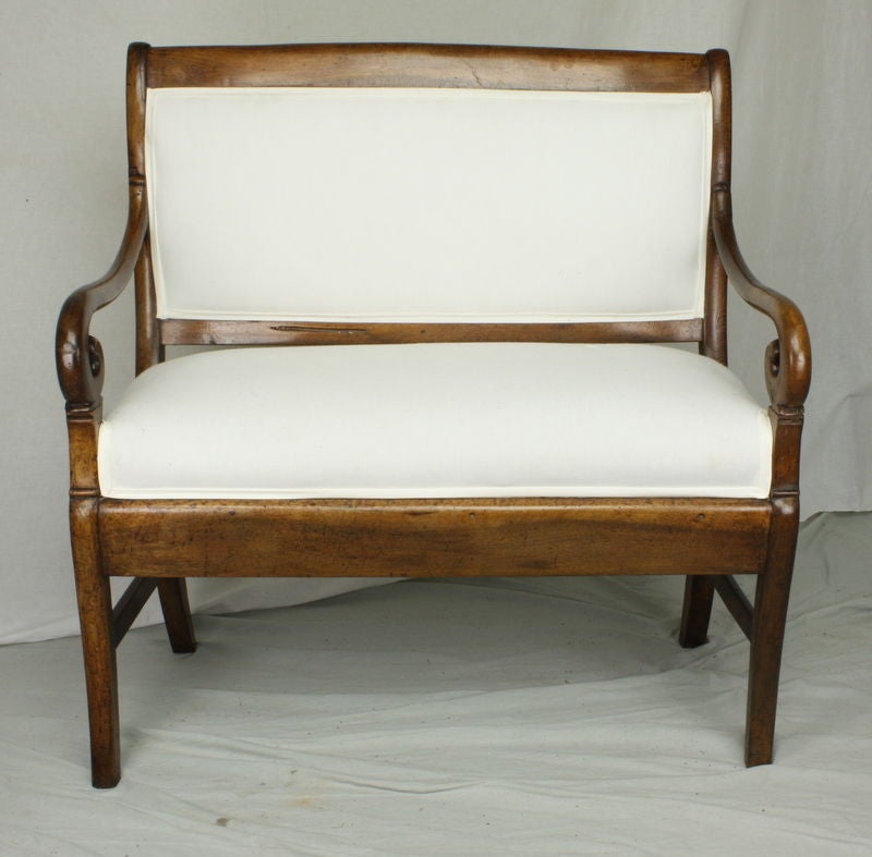 An antique upholstered settee from France. Graceful and elegant. Shallow seat depth (15 1/2