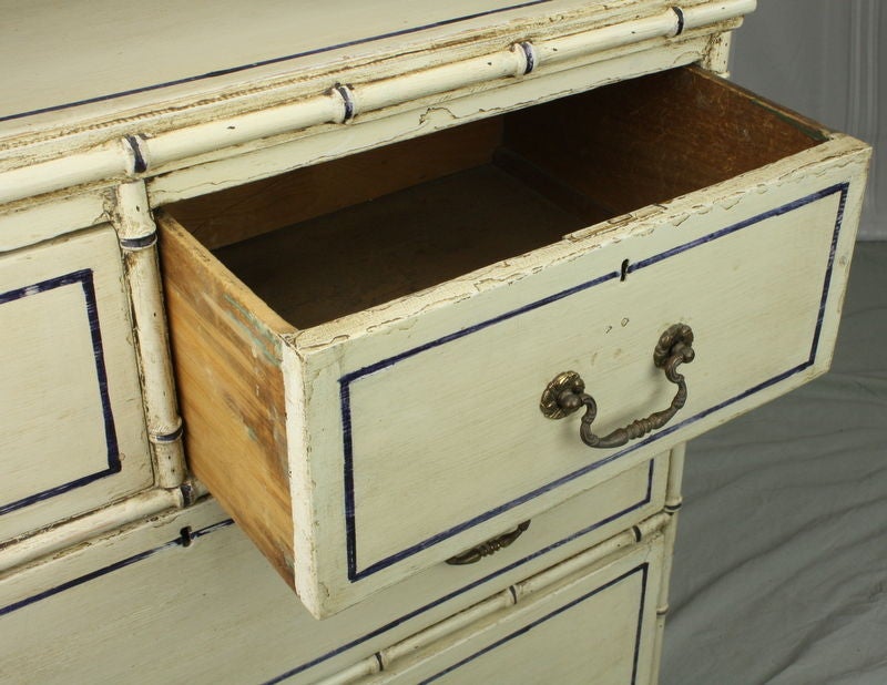 A small antique faux bamboo bureau from England. Very charming. Newly painted (but distressed) in a creamy beige with navy accents. The smaller size lends itself to many uses, beside a bed or as a side table. Now reduced by  1/3 from $2150 list. 