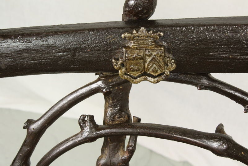 Antique fir cone chair from the Ardeches mountain region near Avignon. Very decorative and fun! We think that the three medallions are possibly a family crest. Arm height is 28