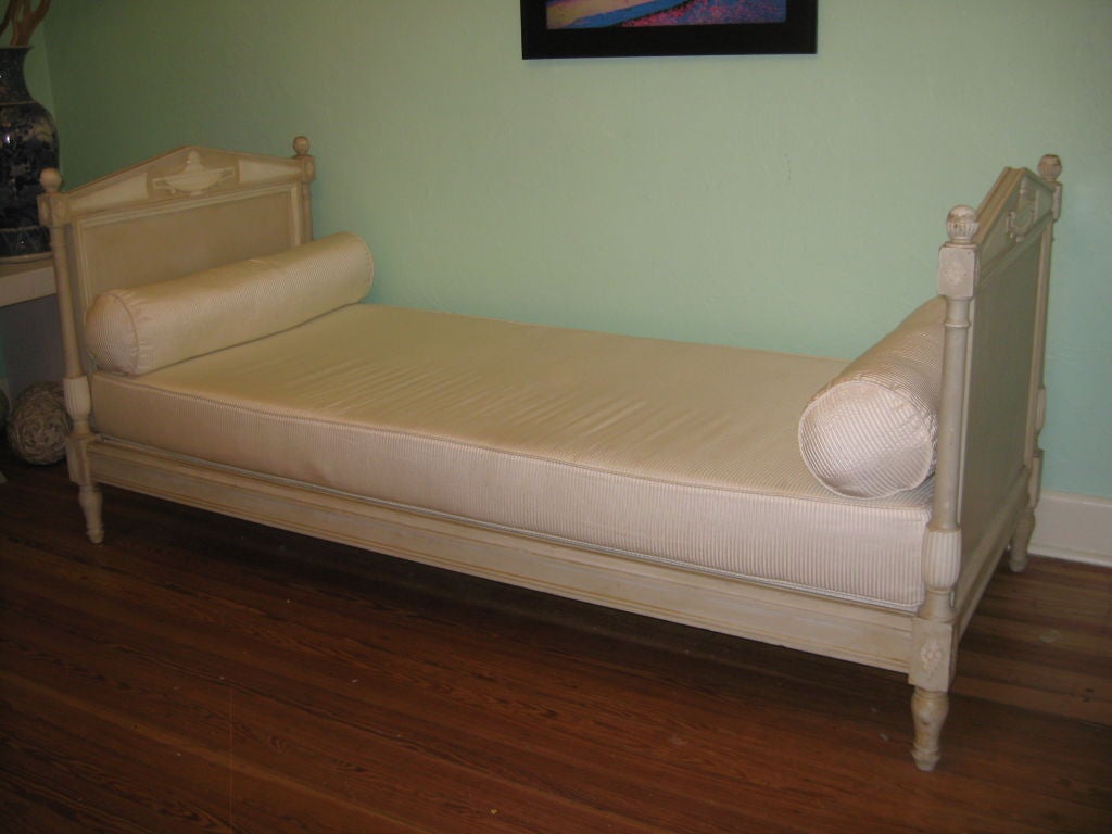 A painted and carved French daybed in a Directoire style. New cushion and bolsters.