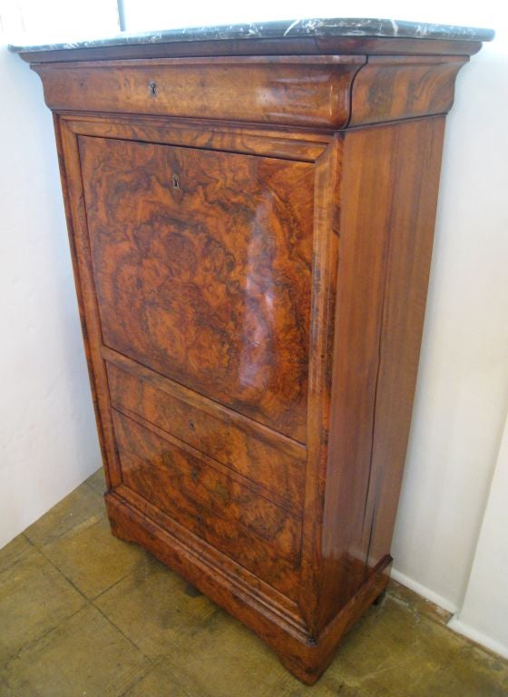 Louis Philippe secretary with original Saint Anne gray marble top. Interior has new leather. Three hidden compartments.

Matched bookend walnut veneer.