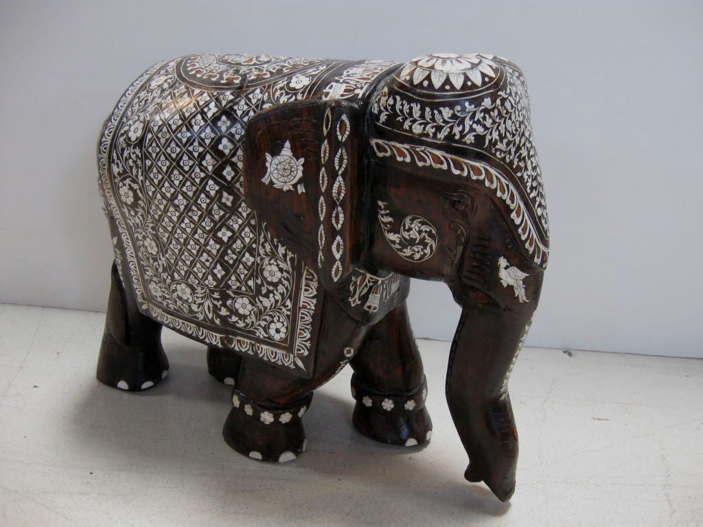 Wonderful carving of elephant in ebony wood, with ivory  inlay.  Beautiful form and detail.