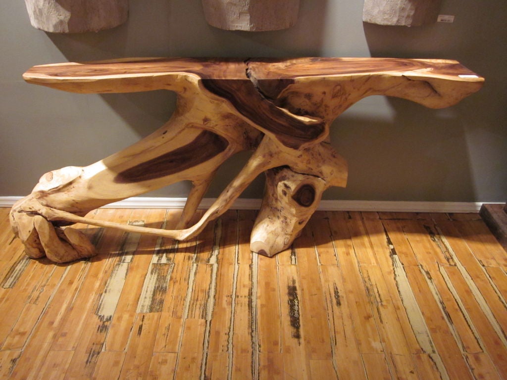 A sculptural free-form console or sofa table in the neo-Primitive / rustic tradition composed of carved and reclaimed monkey wood.

There are variety of sizes and models to choose from. Price will depend on size. Contact the gallery for details.