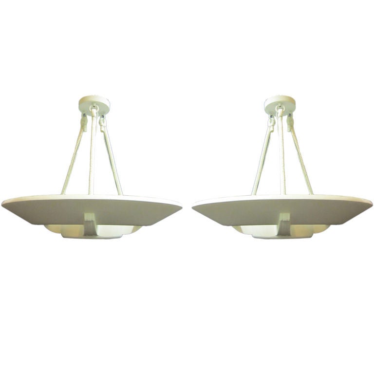 Two suspended plaster disc chandeliers / pendants / flush mount fixtures by Arlus embracing French Art Deco and an emerging modern movement. Each piece is suspended via nylon ropes connected to rings at the canopy.

Signed: Arlus on interior of