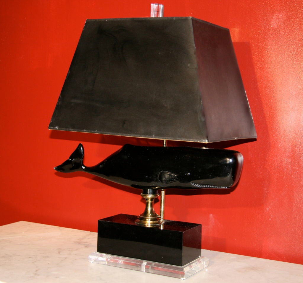 There she blows.... 50s whale form made into a light in the 70s on a chic lacquered metal base with plexi and brass accents. A whimsical elegant piece.