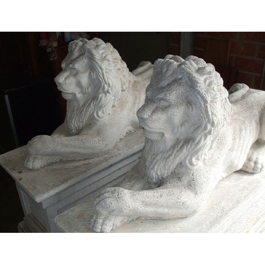 Pair of composition stone lions on bases.  20th century.
