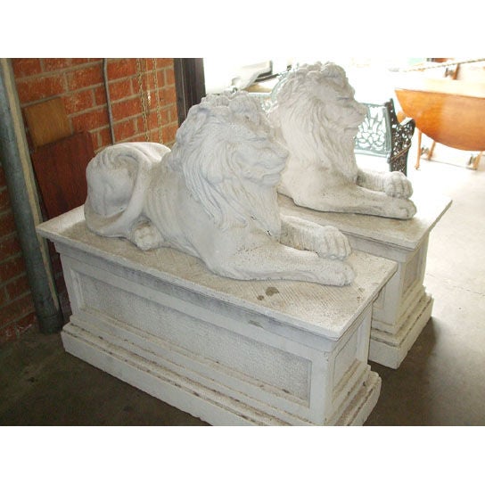 Pair of composition stone lions on bases. In Excellent Condition For Sale In Los Angeles, CA