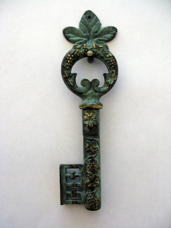 Vintage German brass skeleton key cork screw with great patina.  Key handle opens to reveal the cork screw and the handle is used as a bottle opener.  Includes cork screw hanger (height incl hanger).