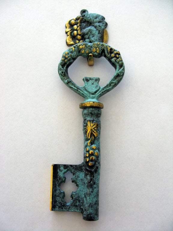 Vintage German brass skeleton key cork screw with great patina.  Key handle opens to reveal the cork screw and the handle is used as a bottle opener.  Includes cork screw hanger (height incl hanger).