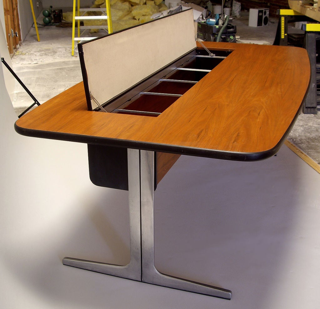 Unusual Herman Miller Action Office desk. Designed by George Nelson. Features two drawers and a leather panel that flips up to reveal file storage. The back of the panel can be used to pin notes or displays. The top is original walnut. Legs are